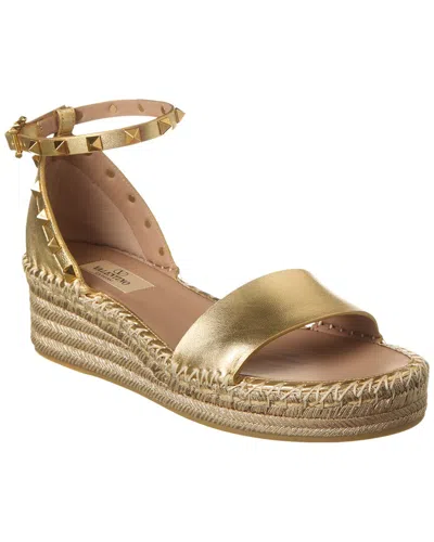 Shop Valentino Rockstud 50 Leather Wedge Sandal In Gold
