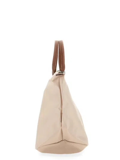 Shop Longchamp Le Pliage Medium Bag In Beige