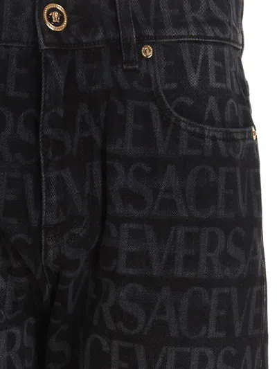 Shop Versace Logo Print Jeans In Black