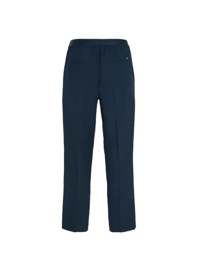 Shop Tommy Hilfiger Slim Fit Trousers With Logo At The Waist In Desert Sky