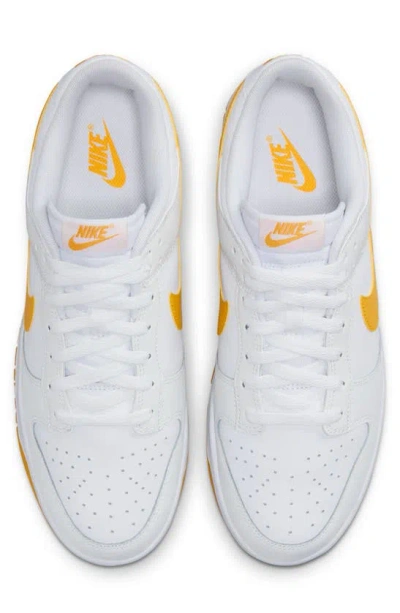 Shop Nike Dunk Low Retro Basketball Shoe In White/ University Gold/ White