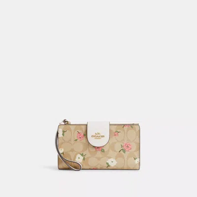 Shop Coach Outlet Phone Wallet In Signature Canvas With Floral Print In Beige