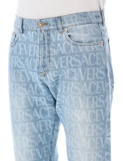 Shop Versace Allover Jeans In Blue