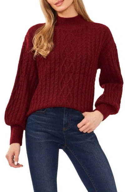 Shop Cece Mock Neck Cable Stitch Sweater In Earth Red