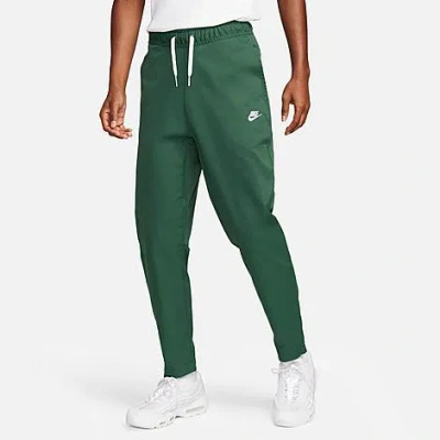 Shop Nike Men's Club Woven Tapered Pants In Fir/white