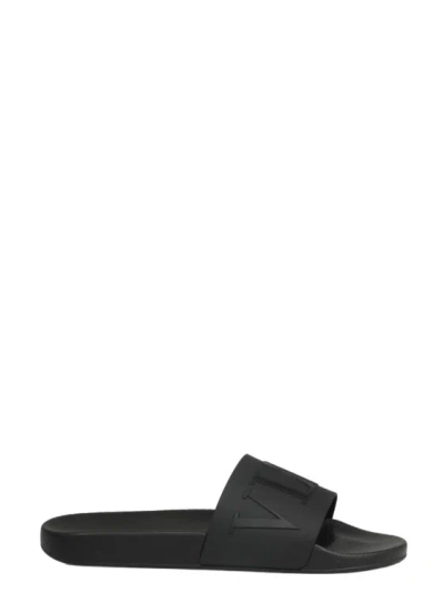 Shop Valentino Vltn Slide Sandals In Black