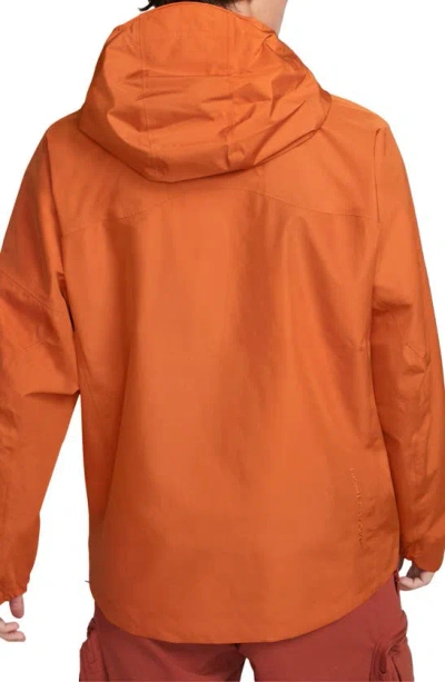 Shop Nike Storm-fit Adv Acg Chain Of Craters Jacket In Campfire Orange/ Summit White
