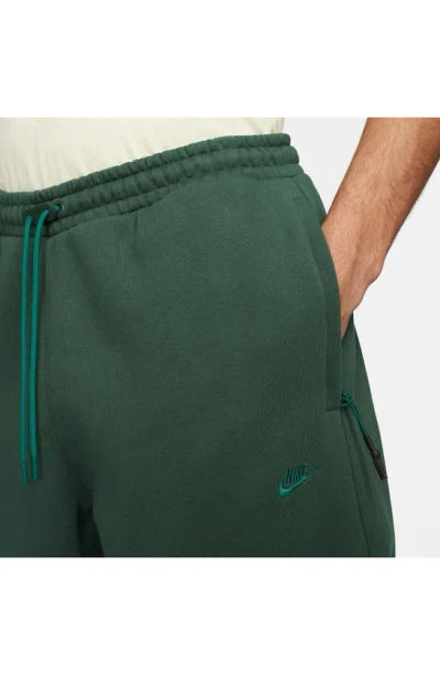 Shop Nike Therma-fit Tech Pack Water Repellent Fleece Sweatpants In Fir/ Fir