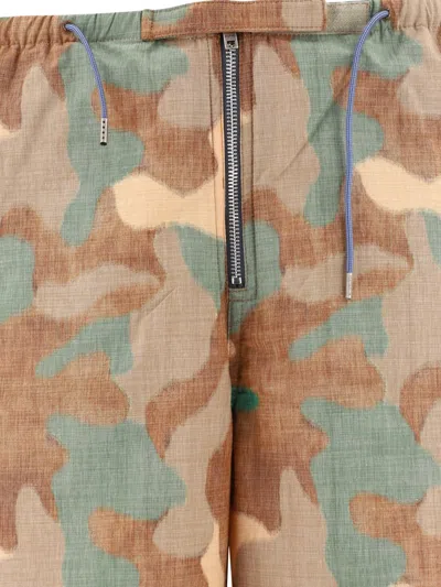 Shop Acne Studios Camo-print Trousers In Beige