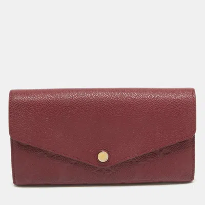 LOUIS VUITTON Pre-owned Flamme Monogram Empreinte Leather Sarah Wallet In Red
