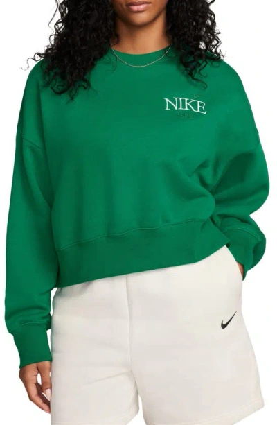 Shop Nike Phoenix Fleece Varsity Oversize Crewneck Sweatshirt In Malachite