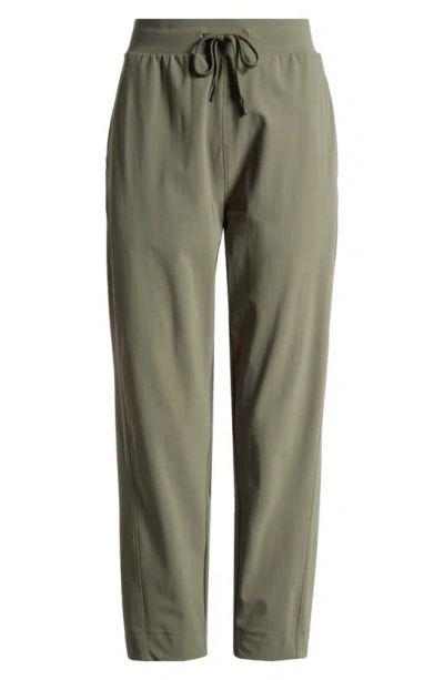 Shop Sweaty Betty Explorer Tapered Athletic Pants In Ivy Green