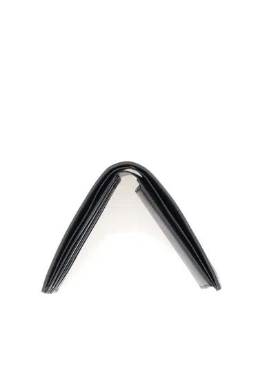 Shop Balenciaga Logo Print Flap-over Wallet In Black