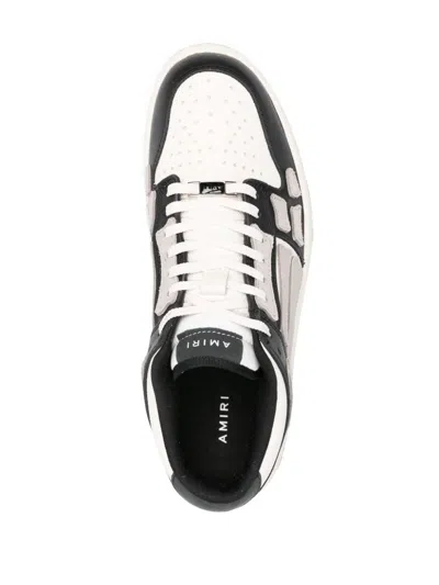 Shop Amiri 'skel Top Low' Sneakers In Nero E Bianco