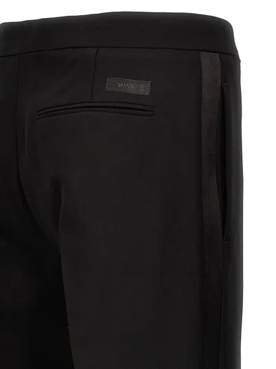 Shop Versace Trousers In Black