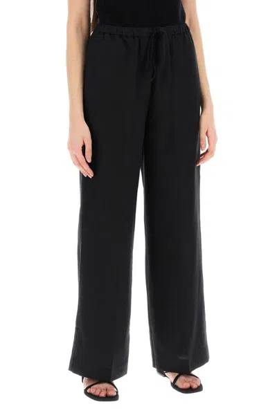 Shop Totême Toteme Lightweight Linen And Viscose Trousers In Black