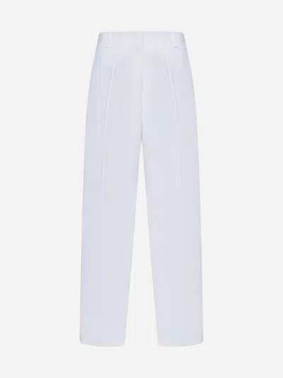 Shop Jacquemus Ovalo Trousers In White