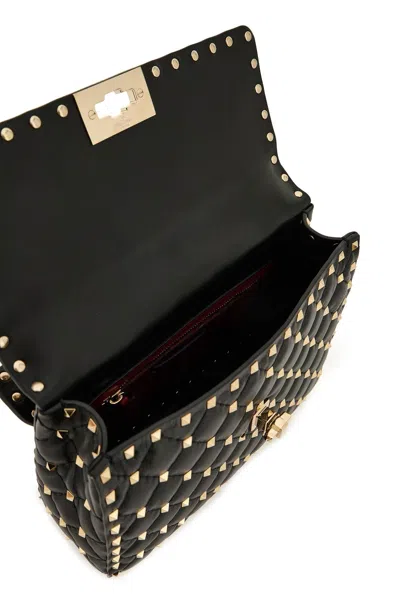 Shop Valentino Garavani Rockstud Spike Handbag In 黑色的
