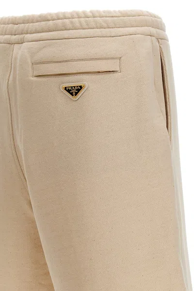 Shop Prada Men Triangle Logo Bermuda Shorts In Cream
