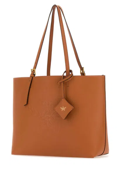 Shop Mcm Handbags. In Beige O Tan