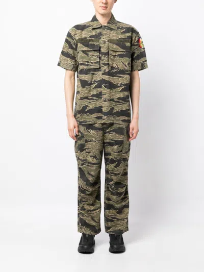 Shop Maharishi Camouflage-print Loose-fit Trousers