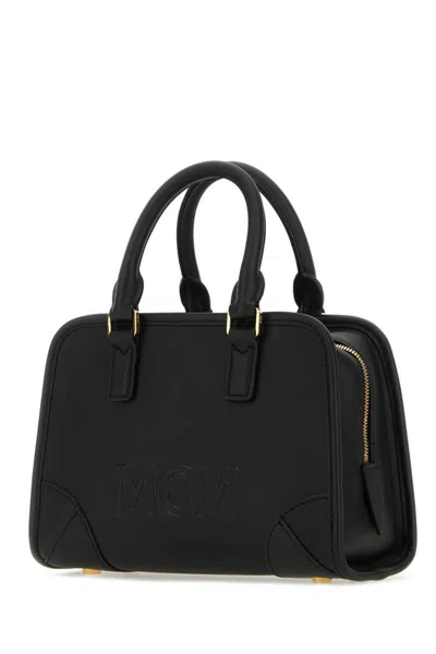 Shop Mcm Handbags. In Black