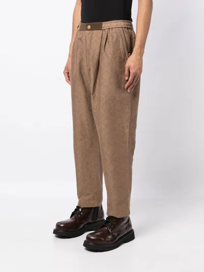 Shop White Mountaineering Geometric-print Tapered Trousers