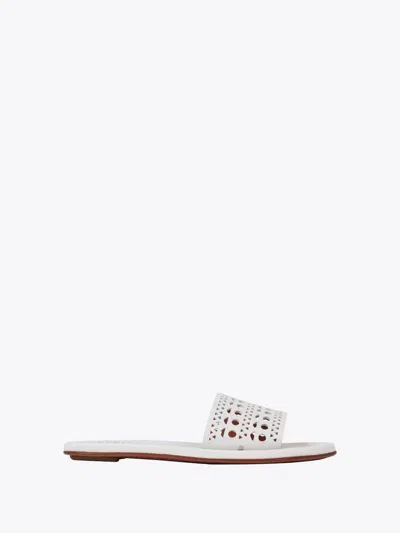 Shop Alaïa Perforated Flat Mules Shoes In White