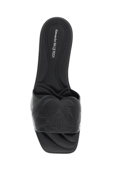 Shop Alexander Mcqueen Leather Slides With Embossed Seal Logo In Nero