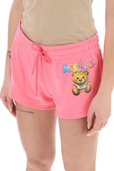 Shop Moschino Logo Printed Shorts In Fuxia