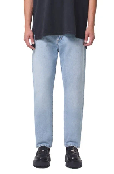 Shop Agolde Curtis Relaxed Tapered Jeans In Conflict