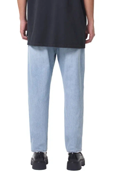 Shop Agolde Curtis Relaxed Tapered Jeans In Conflict
