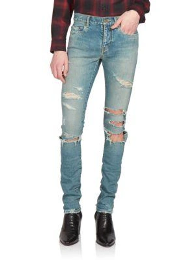 Shop Saint Laurent Trashed Skinny Denim Jeans In Distressed-blue