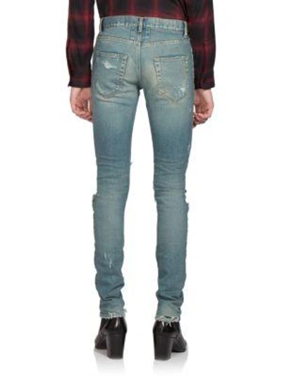 Shop Saint Laurent Trashed Skinny Denim Jeans In Distressed-blue