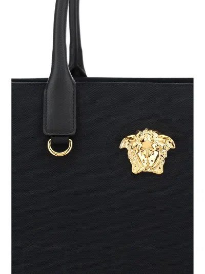 Shop Versace Handbags In Black- Gold