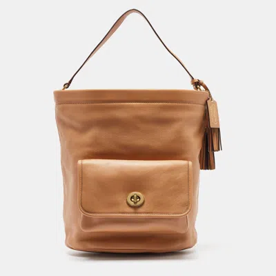 Shop Coach Leather Legacy Tassel Bucket Bag In Beige