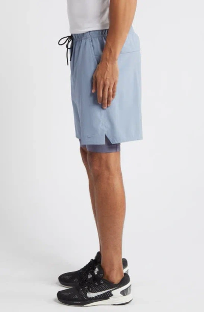 Shop Nike Dri-fit Unlimited 2-in-1 Versatile Shorts In Ashen Slate/ Light Carbon