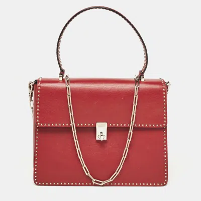 Shop Valentino Leather Rockstud Top Handle Bag In Red