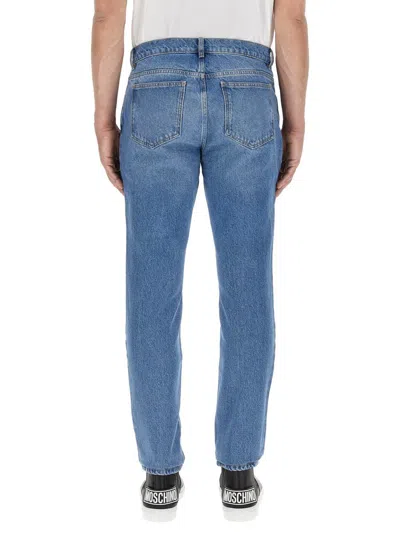 Shop Moschino Teddy Patch Jeans In Blue