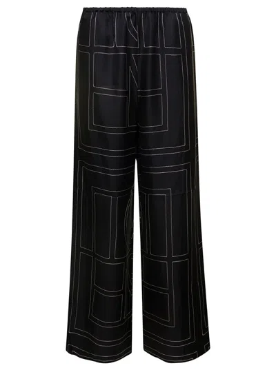 Shop Totême Black Loose Pants With Monogram Print In Silk Woman