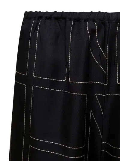 Shop Totême Black Loose Pants With Monogram Print In Silk Woman