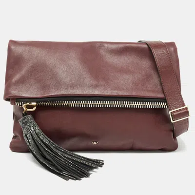 Shop Anya Hindmarch Leather Fold Over Tassel Crossbody Bag In Red