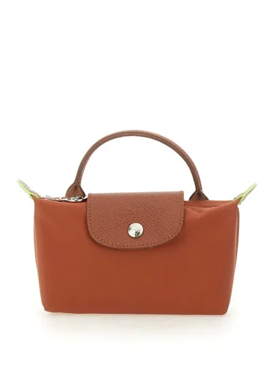 Shop Longchamp "le Pliage" Clutch Bag With Handle In Brown