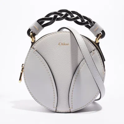 Shop Chloé Mini Round Daria Light Leather Crossbody Bag In Gold