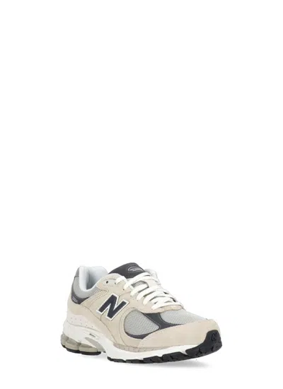 Shop New Balance Sneakers Beige