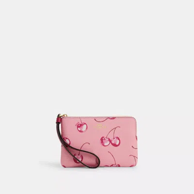 Shop Coach Outlet Corner Zip Wristlet With Cherry Print In Pink