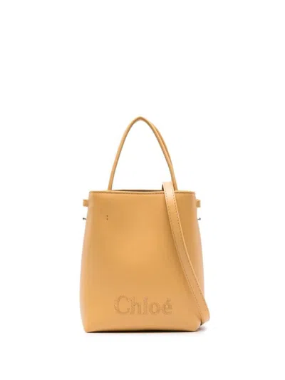 Shop Chloé Sense Micro Leather Bucket Bag In Yellow