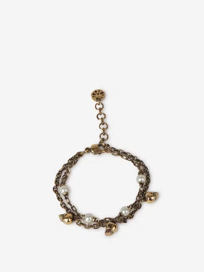Shop Alexander Mcqueen Pearl Skulls Bracelet In Gold