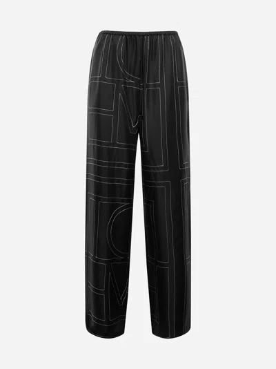 Shop Totême Monogran Silk Trousers In Black