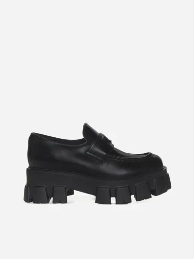 Shop Prada Monolith Leather Loafers In Black